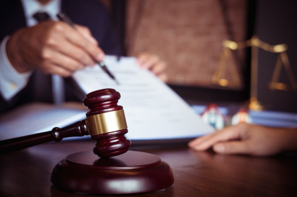 a judge's gavel on a desk in a courtroom stock photo