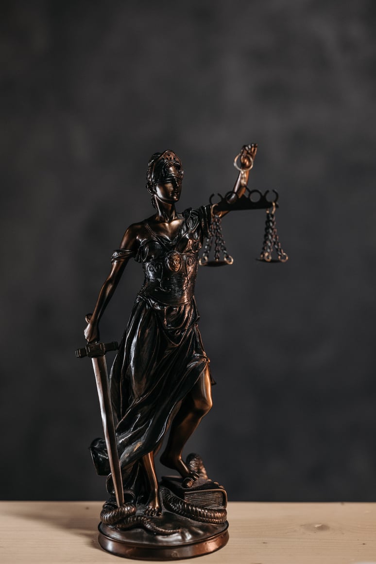 a statue of lady justice holding a sword and scales