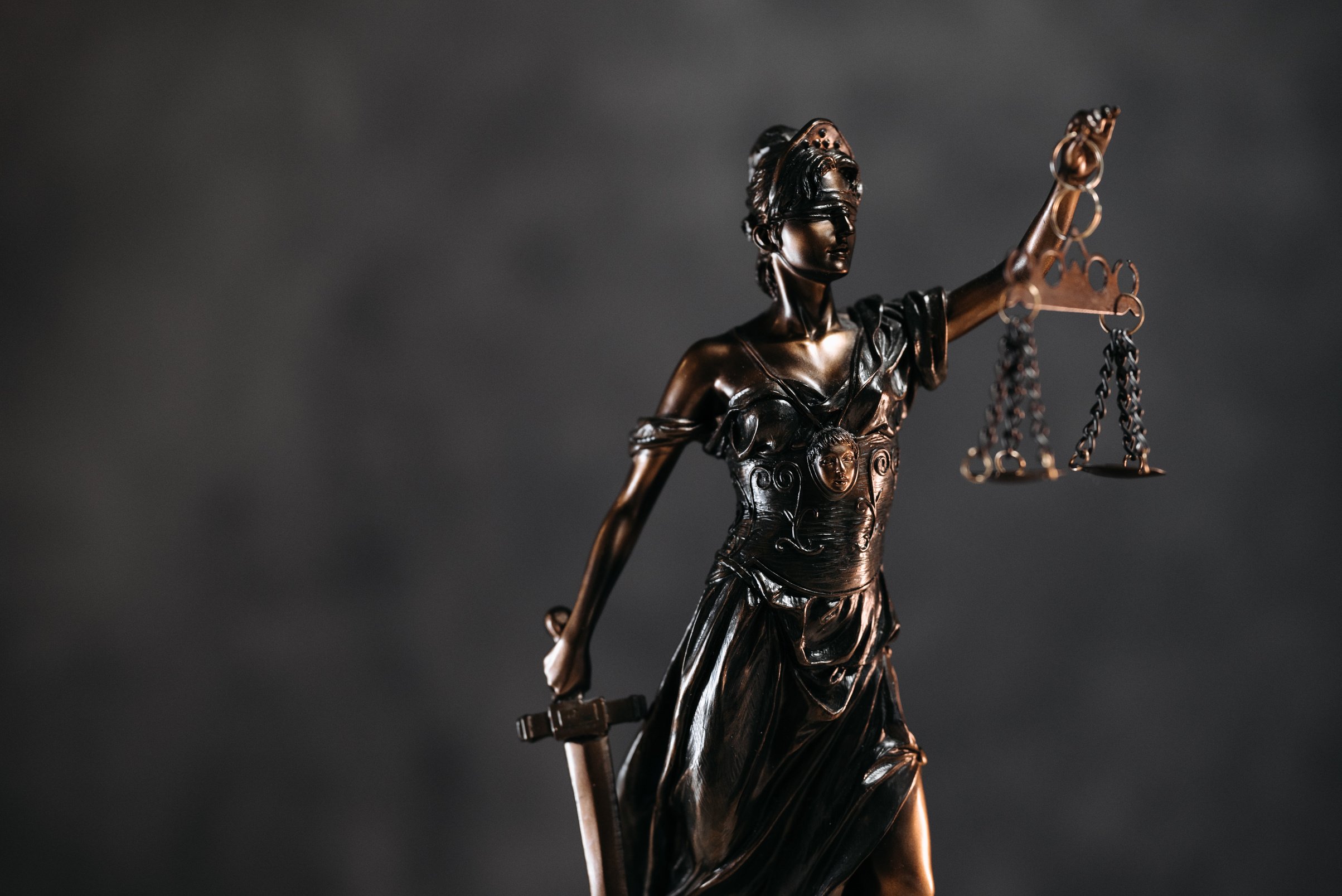 bronze statue of lady justice holding scales